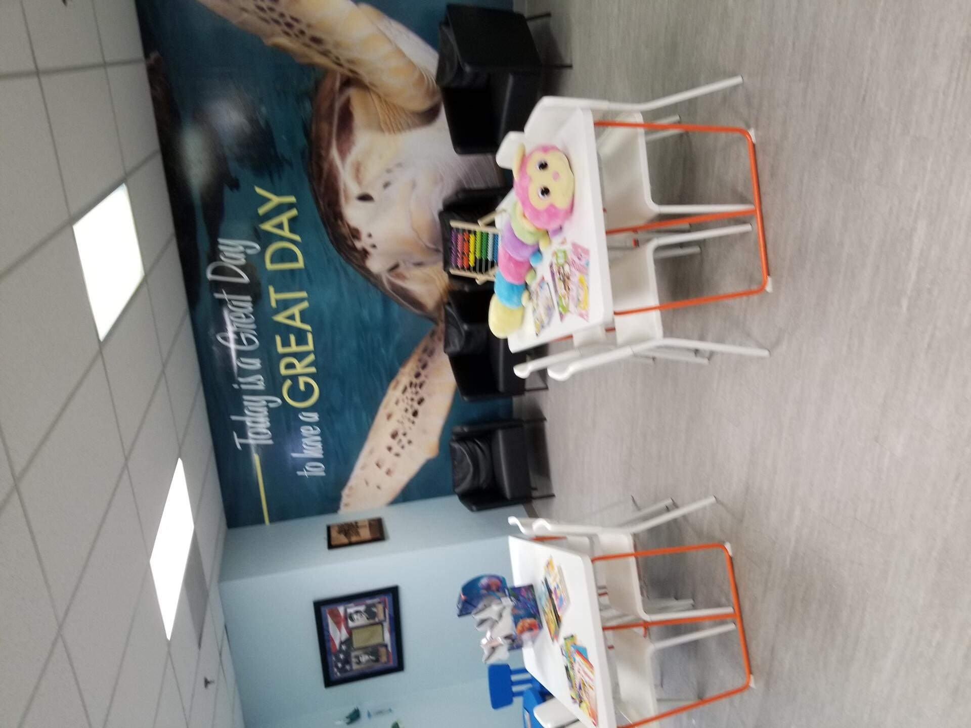 Mavis Room — learning center with tables, chairs, and "Today is a Great Day" turtle mural