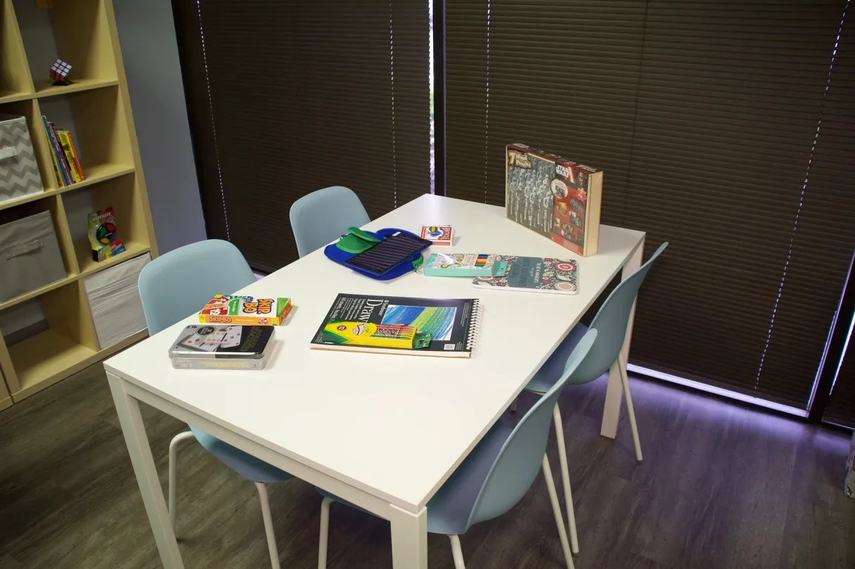 Rufus Room activity table with art supplies and games for teens