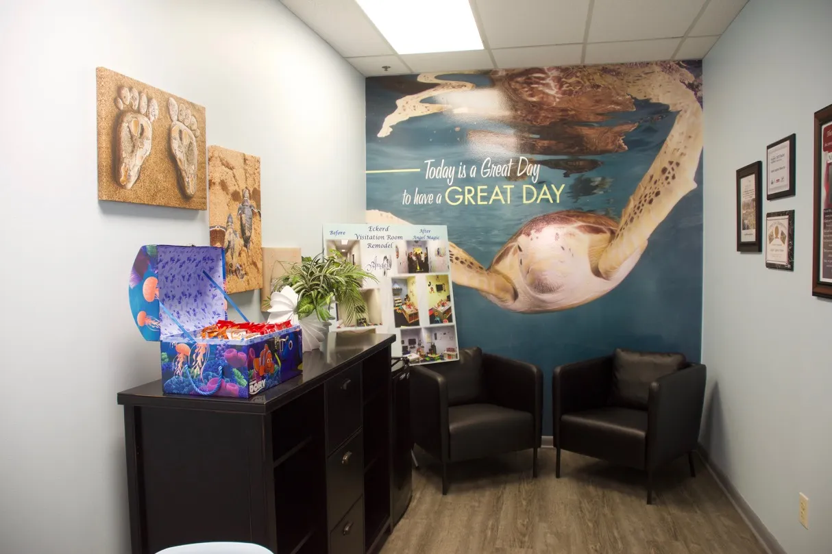 Angel Visitation Center reception area with dolphin mural and seating
