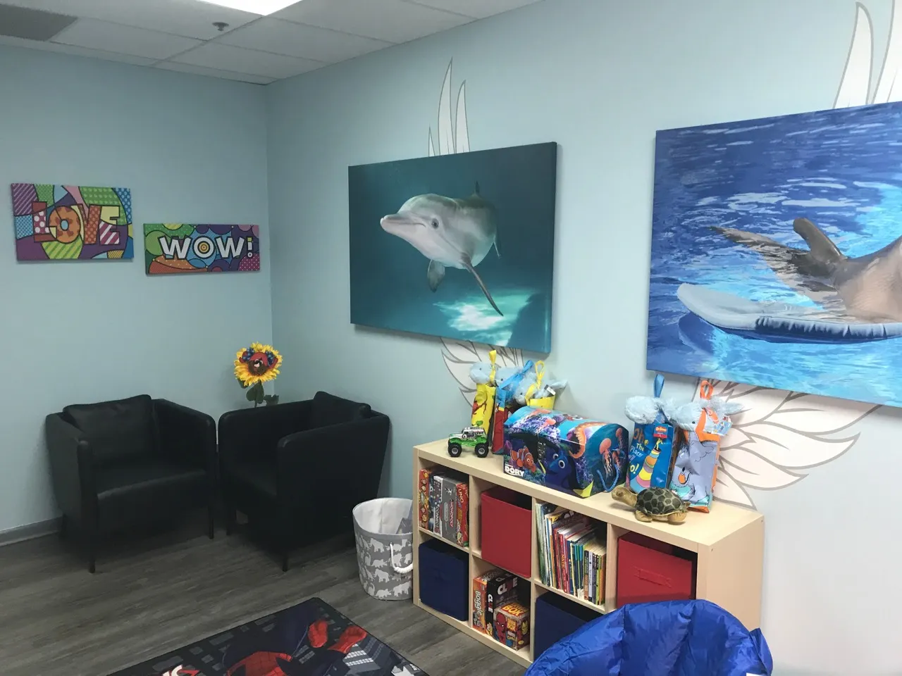 Winter Room at Angel Visitation Center — dolphin artwork, books, toys, and comfortable seating